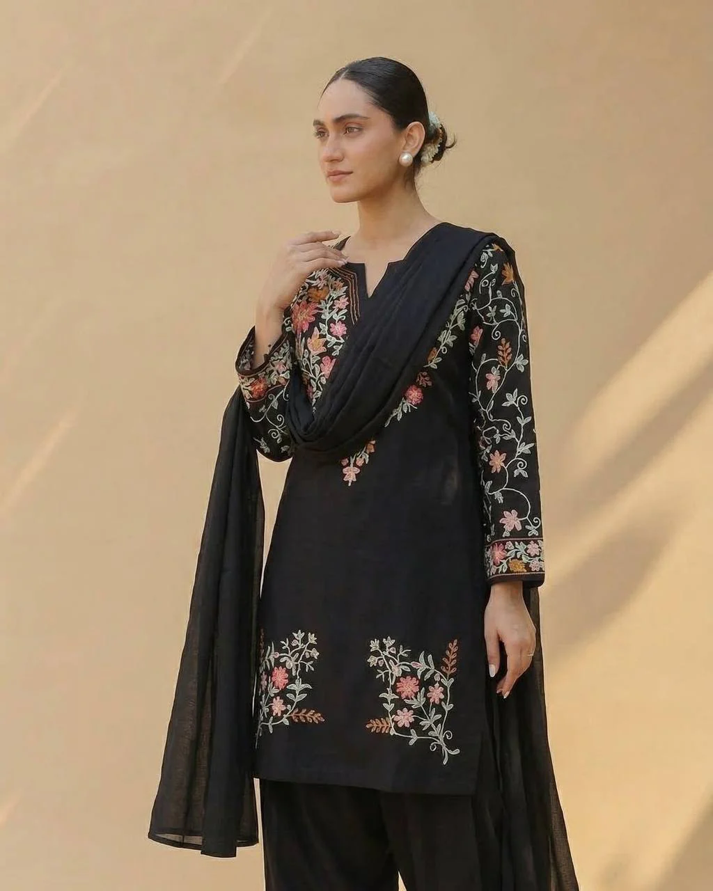 Timeless Black Attire with Floral Accents - Image 3