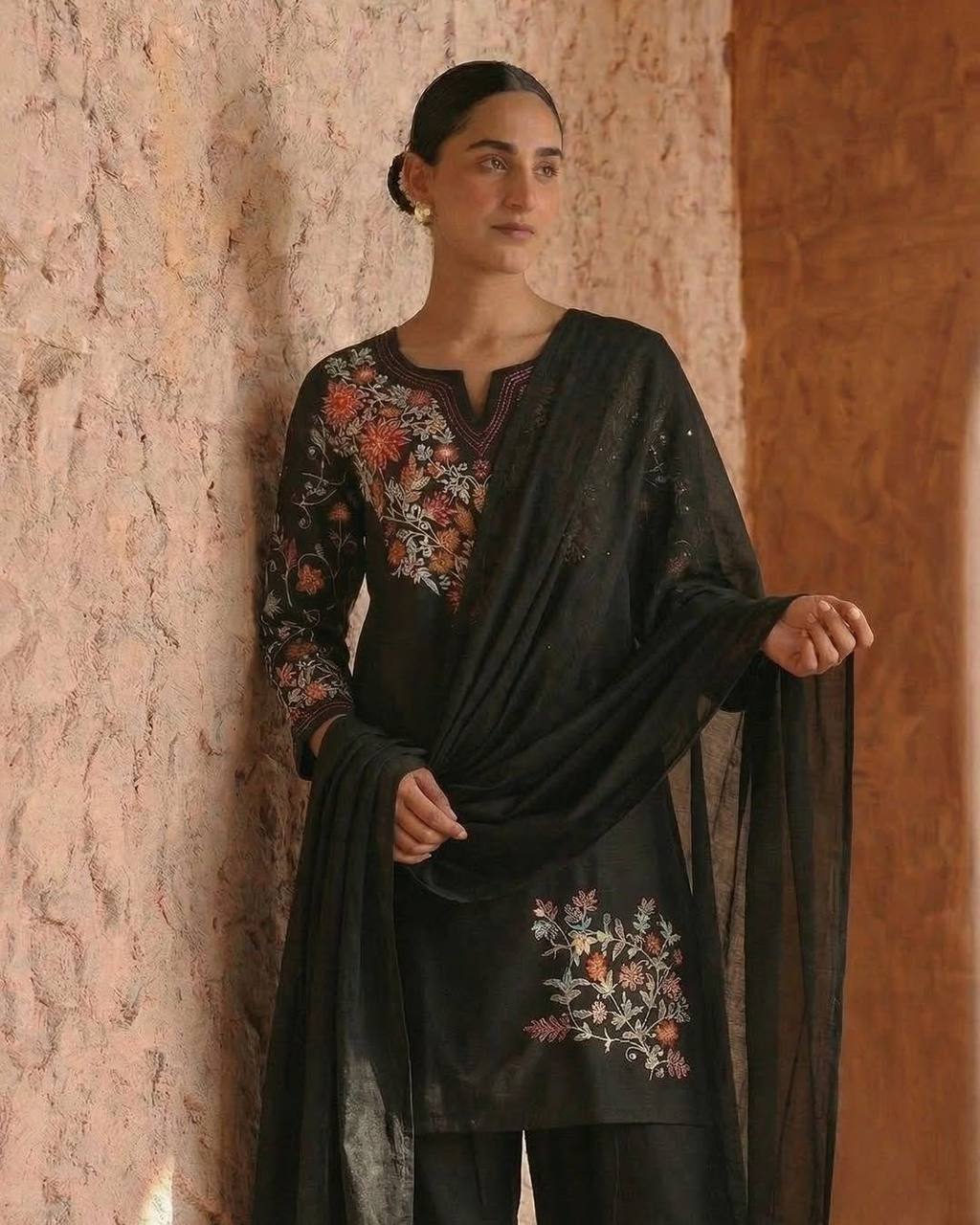 Timeless Black Attire with Floral Accents - Image 4
